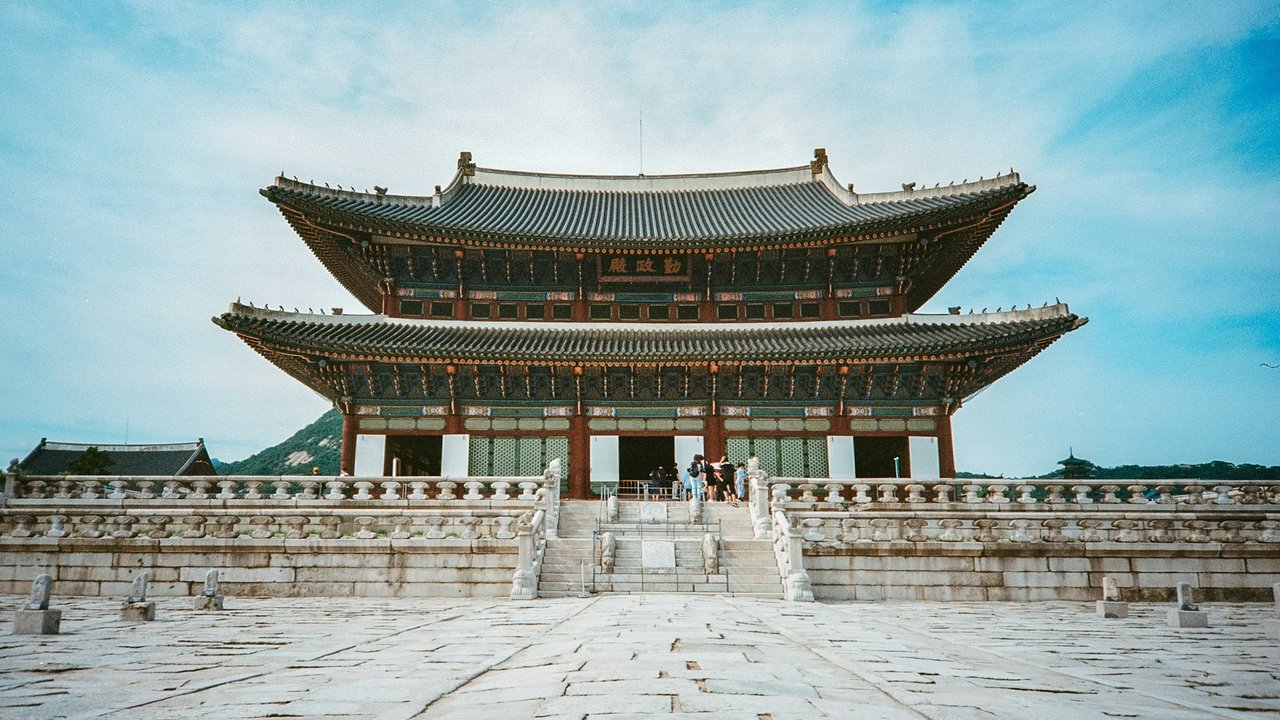 Gyeongbokgung Palace main hall and stone courtyard under a blue sky