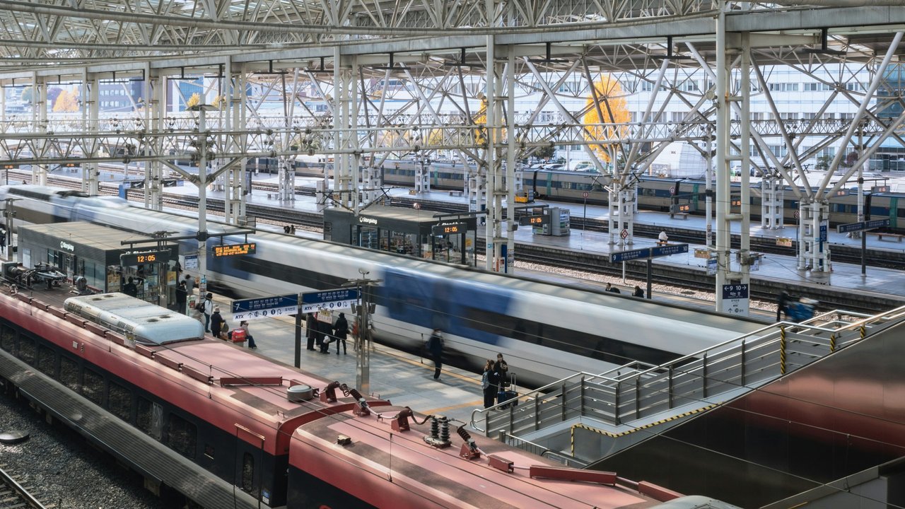 High-speed trains waiting at the platforms of a large Seoul railway station