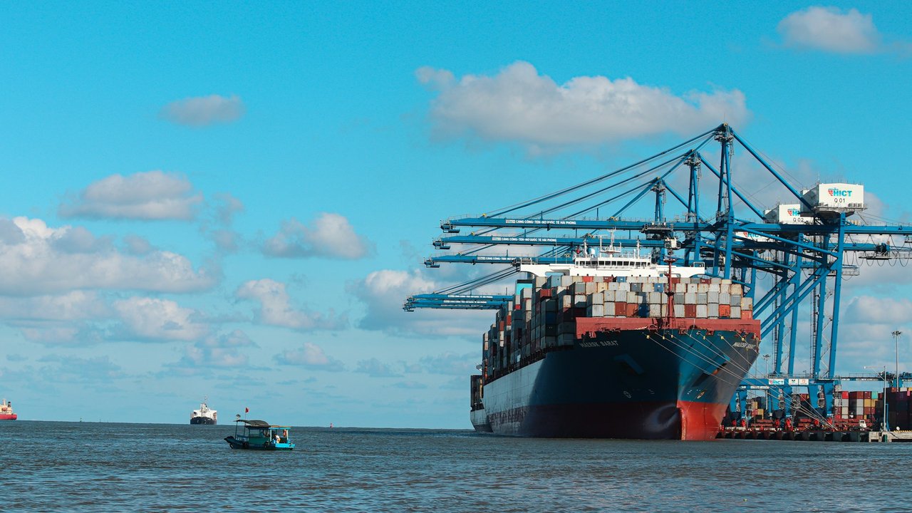 Container ship berthed under gantry cranes at a port